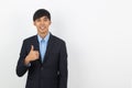 Young handsome asian business man smiling and showing thumbs up isolated on white background. Royalty Free Stock Photo