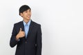 Young handsome asian business man smiling and showing thumbs up isolated on white background. Royalty Free Stock Photo