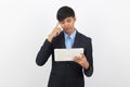 Young handsome asian business man using tablet computer with doubts Royalty Free Stock Photo