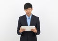 Young handsome asian business man using tablet computer with smiling Royalty Free Stock Photo