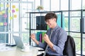 Portrait of young asian businessman triumphant and celebrate with arms up for job success in office Royalty Free Stock Photo