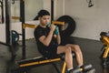 A young handsome asian man does rapid weighted dumbbell punches on a decline bench. Boxing or advanced fitness training regimen at