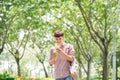 Young handsome Asian man enjoying his smart phone in public park Royalty Free Stock Photo