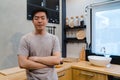 Young handsome asian man prepare salad food and cooking in the kitchen. Royalty Free Stock Photo