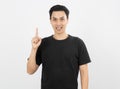 Young handsome asian man smiling with braces and looking at camera with finger pointing up isolated on white background. Royalty Free Stock Photo