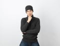 Young handsome asian man wearing grey sweater and beanie thinking an idea while looking to camera on white background.