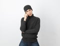 Young handsome asian man wearing grey sweater and beanie thinking an idea while looking to camera Royalty Free Stock Photo