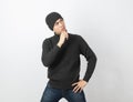 Young handsome asian man wearing grey sweater and beanie thinking an idea while looking up on white background.