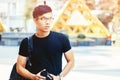 Young handsome asian men wearing casual black tshirt and backpack at day in Sai Gon city, Vietnam Royalty Free Stock Photo