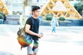 Young handsome asian men wearing casual plain shirt and backpack in Sai Gon city, Vietnam. Royalty Free Stock Photo