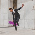 Young handsome Asian model jumping with his skateboard