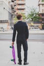 Young handsome Asian model posing with his skateboard Royalty Free Stock Photo