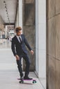 Young handsome Asian model posing with his skateboard Royalty Free Stock Photo