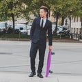 Young handsome Asian model posing with his skateboard Royalty Free Stock Photo