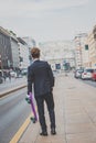 Young handsome Asian model walking with his skateboard Royalty Free Stock Photo