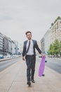 Young handsome Asian model walking with his skateboard Royalty Free Stock Photo