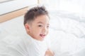Young boy smiling on bed Royalty Free Stock Photo