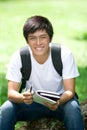 Young handsome Asian student with laptop Royalty Free Stock Photo