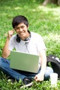 Young handsome Asian student with laptop and smile in outdoor Royalty Free Stock Photo