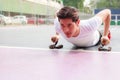 Young handsome athlete man doing push up in fitness outdoor sport club. Sport, Exercise, Healthy Lifestyle concept Royalty Free Stock Photo