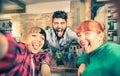 Young handsome bartender flirting with beautiful girls at bar Royalty Free Stock Photo