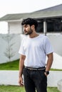 A young handsome bearded man wearing a blank white shirt doing a pose outdoor Royalty Free Stock Photo