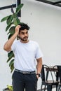 A young handsome bearded man wearing a blank white shirt doing a pose outdoor Royalty Free Stock Photo