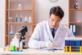 The young handsome biochemist working in the lab Royalty Free Stock Photo