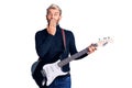 Young handsome blond man playing electric guitar covering mouth with hand, shocked and afraid for mistake Royalty Free Stock Photo