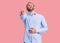 Young handsome blond man wearing elegant shirt laughing at you, pointing finger to the camera with hand over body, shame Royalty Free Stock Photo