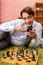 The young handsome boss playing chess during break Royalty Free Stock Photo