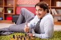 The young handsome boss playing chess during break Royalty Free Stock Photo