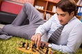 The young handsome boss playing chess during break Royalty Free Stock Photo