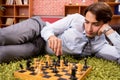 Young handsome boss playing chess during break Royalty Free Stock Photo