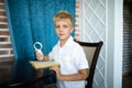 Boy holding a magnifying glass