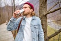 young handsome brutal bearded man traveling in the wild nature with thermos Royalty Free Stock Photo