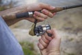 Young handsome brutal caucasian man in casual outfit fishing on Royalty Free Stock Photo