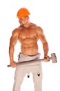 Young and handsome builder with a sledgehammer and Royalty Free Stock Photo