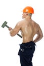 Young and handsome builder with a sledgehammer and body Royalty Free Stock Photo