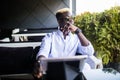 Young handsome business african young man using tablet in outdoor cafe terrace Royalty Free Stock Photo