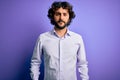 Young handsome business man with beard wearing shirt standing over purple background Relaxed with serious expression on face Royalty Free Stock Photo