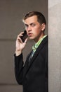 Young handsome business man in black blazer calling on cell phone Royalty Free Stock Photo