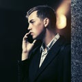 Young handsome business man calling on cell phone on night city street Royalty Free Stock Photo