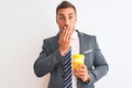 Young handsome business man drinking take away coffee over isolated background cover mouth with hand shocked with shame for