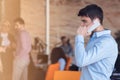 A young, handsome business man at the office building on phone Royalty Free Stock Photo