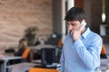 A young, handsome business man at the office building on phone Royalty Free Stock Photo
