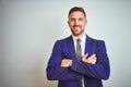 Young handsome business man over white isolated background happy face smiling with crossed arms looking at the camera Royalty Free Stock Photo