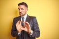 Young handsome business man over yellow isolated background disgusted expression, displeased and fearful doing disgust face Royalty Free Stock Photo