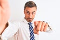 Young handsome business man taking selfie using smartphone over isolated background pointing with finger to the camera and to you, Royalty Free Stock Photo