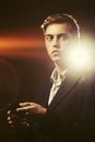 Young handsome business man using cell phone on city street at night Royalty Free Stock Photo